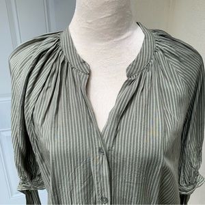 AMANDA GREEN. Green striped shirt, short sleeves with ties around sleeves